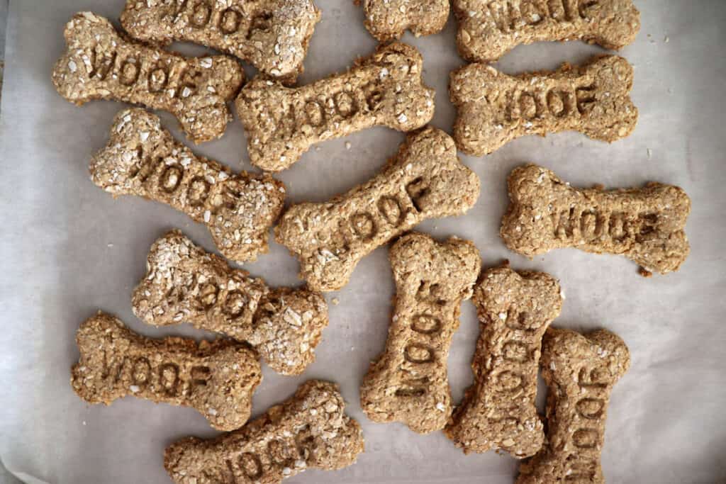 Overhead shot of bone shaped dog treats with the word "woof" stamped in them
